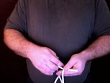 magician grasps rope with left hand
