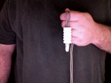 magician then threads rest of mints over both ends of string