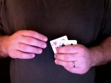 magicain moves first card with thumb