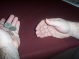 magician reveals three coins are now in his left hand