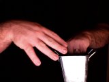 magician tosses coin into the bucket