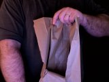 magician tears bag to show banana skin has vanished