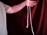 Magician lays rope over his hand
