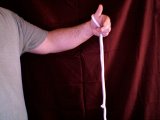 Magician grasps rope with fingers