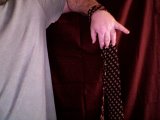 magician grasps tie with fingers
