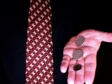 Magician shows three coins in right hand