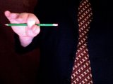 magician holds pencil between thumb and forefinger