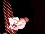 magician pulls out two red jacks