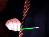 magician holds the pencil between finger and thumb