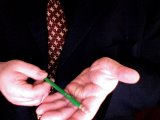 magician holds the pencil in his palm