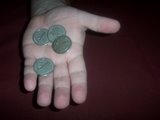 Magician shows all four coins in his left hand