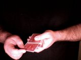 Magician is shown placing card back in the deck