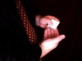 magician reveals gap in paper fold for coin to exit