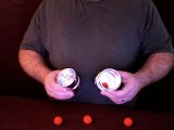 magician stacks the cups