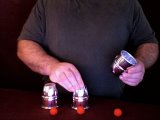magician places the cups on the table