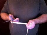 magician cuts the loop with scissors
