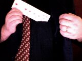 magician puts long card in pocket