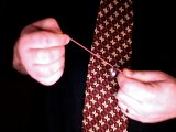 magician releases grip on elastic band slightly