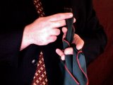 magician passes silk through his fingers