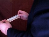 magician folds note lengthways