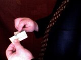 magician begins unfolding the note