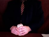 magician puts napkin over the salt shaker