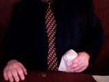 magician lifts salt shaker and drops it into his lap